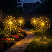 Gold solar starburst lights placed in a landscaped bed