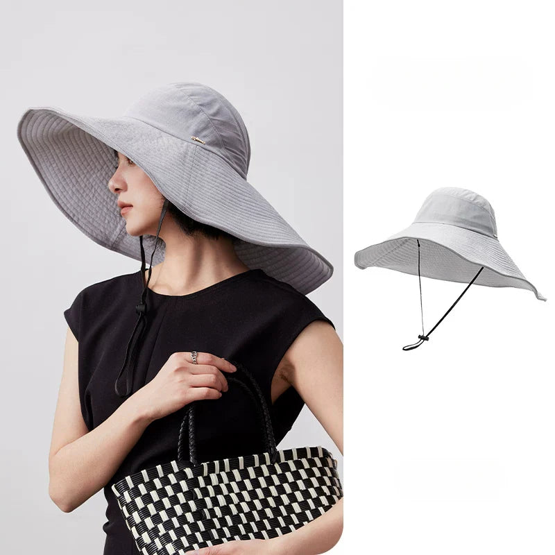 Blue gray foldable wide brim sun hat on a white background