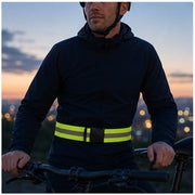 Reflective waist belt worn by a cyclist at dusk