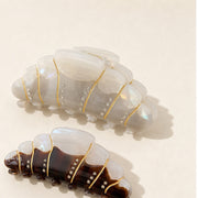 Pearl cream and espresso croissant hair claw clips on warm white background
