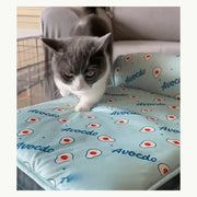Cat using the green foldable pet cooling mat
