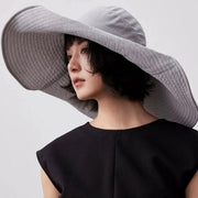 Blue gray foldable sun hat side view with wide structured brim